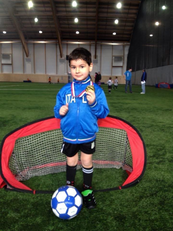 Nico as a child in an Italy jacket with a medal