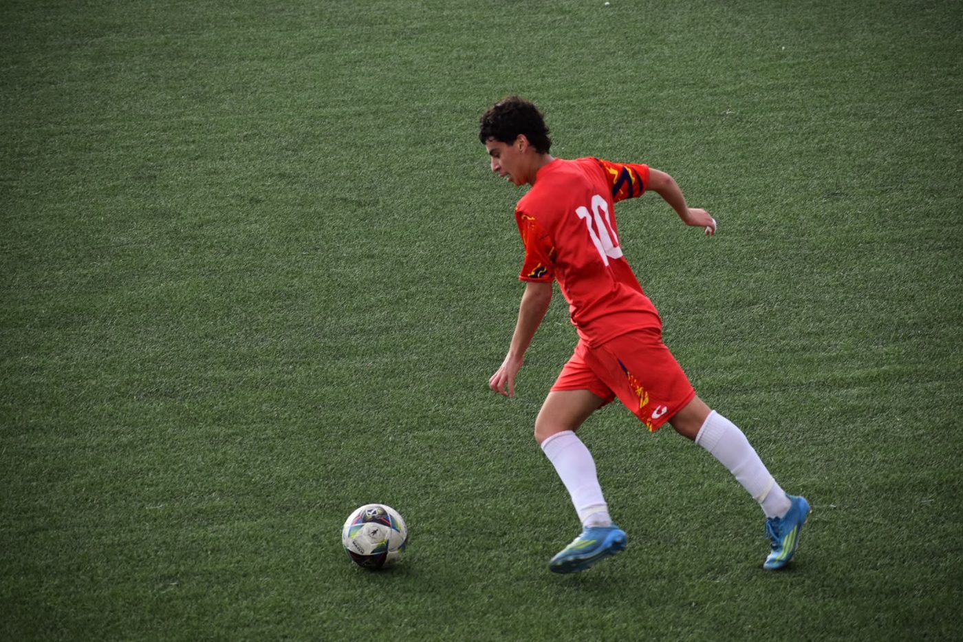Nico carrying the ball in the number 10 shirt