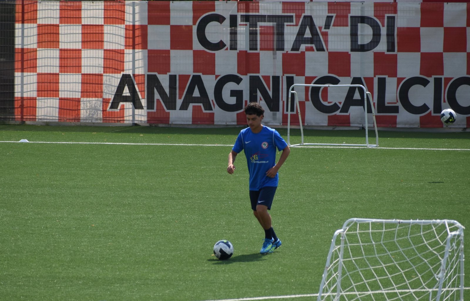 Nico on the ball in front of the Città di Anagni Calcio banner